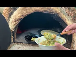 Village pastures in almond blossom season cooking omelet