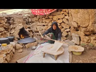Iran nomadic life baking traditional bread in a mountain