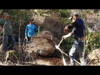 Looking under boulders for gold