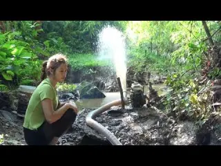 The girl catch a lot of fish in the wild lake by using a