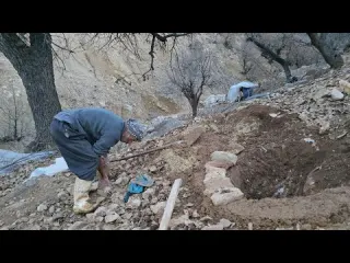Iran nomadic life preparing a toilet well with stones and
