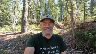 Detecting for gold while exploring a hydro pit in the high