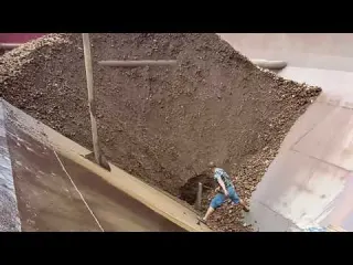 Barge unloads tons of large iron ore Part