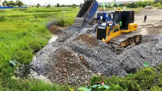 Dump Truck Discharging Crushed Rocks To Fill Wetland Pond