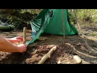 Solo camping by the river rafting building a shelter