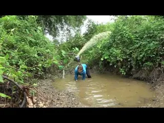 The girl caught a lot of fish in the lake by using a pump