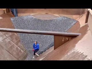 Barge unloading tons of concrete gravel