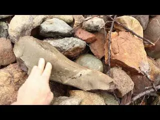 Moving large boulders on the hillside in a race with the