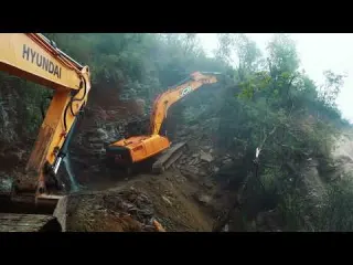 Hyundai Excavator Tackling Rocky Slope Road Building Work