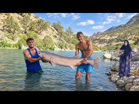 Nomadic Life Catching a Giant Fish in a Rushing River