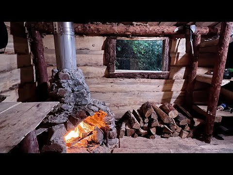 A man makes a window and shutters in his forest hut Solo