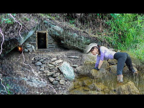 The girl braved the heavy rain, build shelter under a large