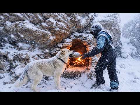 Isolated alone with his pet dog in a cold, snowy mountain