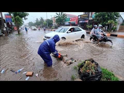 Address road flooding issues by clearing debris and grass