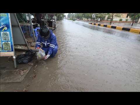 Remove trash from clogged drains during rain