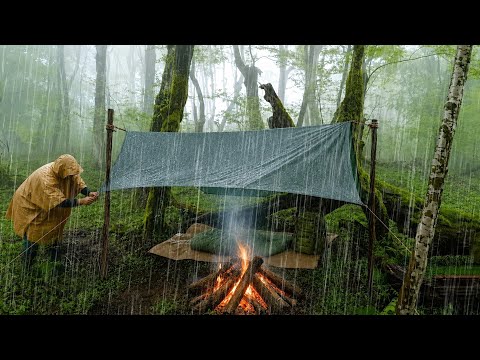 Camping with a Tarp in Heavy Rain Keeping a Fire Burning