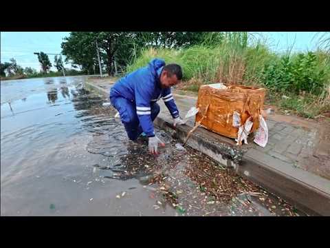 Cleaning sewers clogged with debris after heavy rains