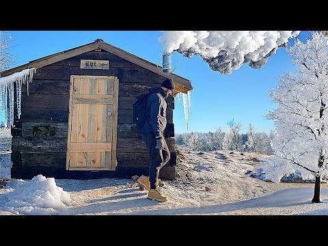 Building of a fishing hut from the sleepers Icy night at