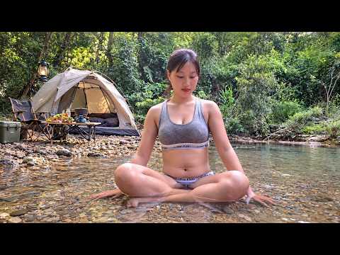 Young Woman Camping by a Crystal-Clear Stream Relaxing