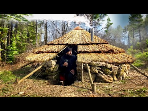 Building of a round bushcraft dugout for survival in the