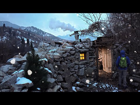 A man is restoring a stone hut in the mountains Spends the