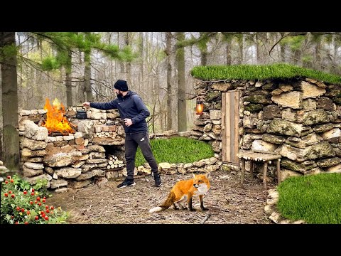 Building a barbecue fireplace near a stone hut photo