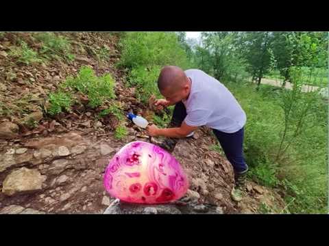 Some huge, colorful stones are embedded in the cliff