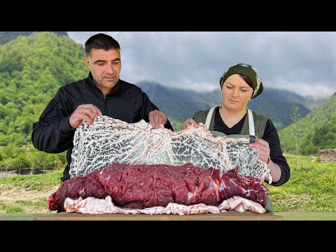 Juicy Meatloaf on a Spit Cooking outdoors in the Mountains