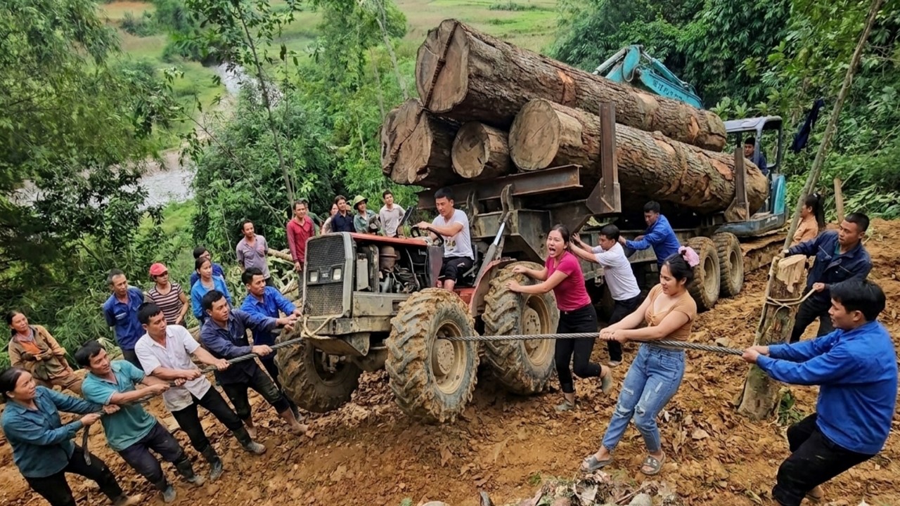 An excavator and several people pushed and pulled the