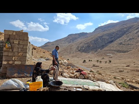 Iran nomadic life washing blankets and clothes to prepare