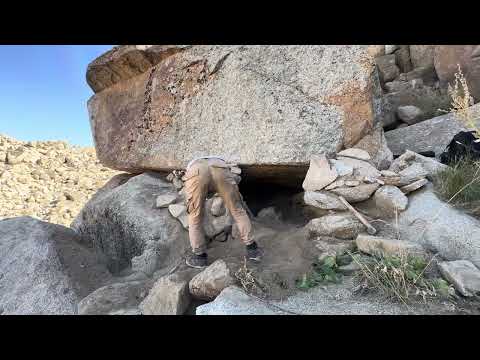 I built a shelter beneath a massive rock to survive the