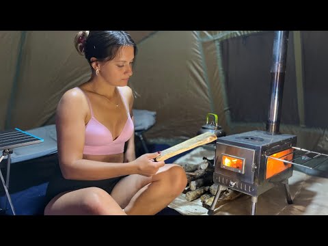 Young Girl Camping Alone by the River Hot Tent in the Rain