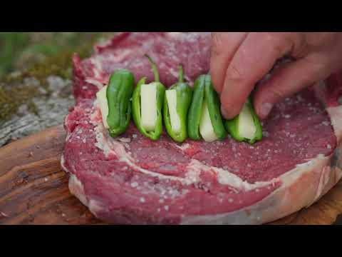 Stuffed Tomahawk Steak with Cheese Cooked in the Forest