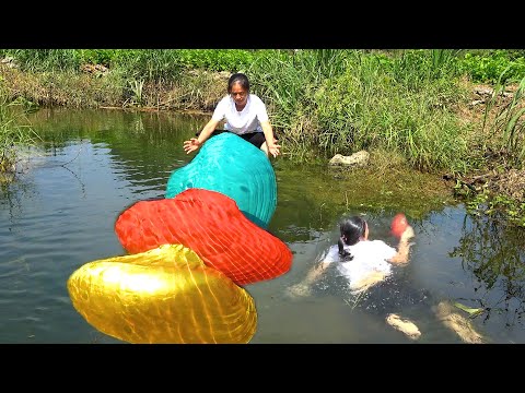 A beautiful woman takes a special clam out of the water and