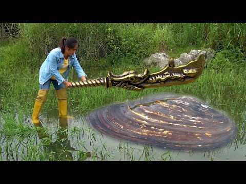 The beautiful woman found an ancient big knife from a clam