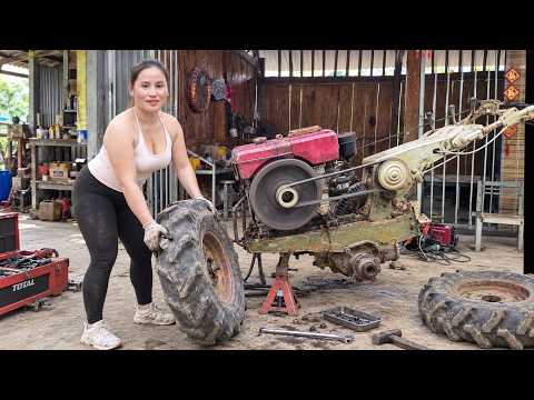 A genius girl repairs an old tractor changing tires and