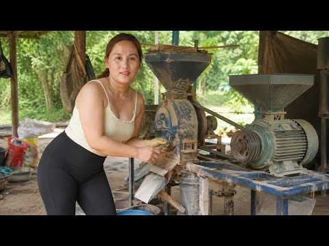 Young woman repairs an old rice milling machine herself a