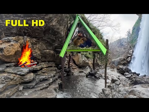 Rock mounted wooden shelter next to the waterfall