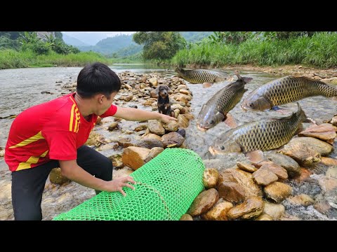 The boy Lam arranged rocks to set a fish trap in a big