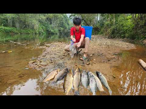 The boy was fishing in the big stream and was lucky enough
