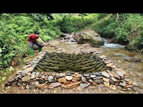 The boy used stacked rocks from the stream to make a fish