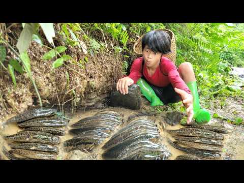 The boy used his hands to catch fish in the stream Luckily