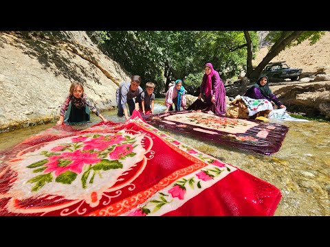 Washing blankets in raging water by a nomadic family