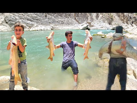 Giant fish caught in a raging river by a young nomadic man