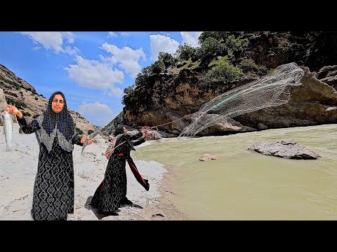 Fishing in the raging river by a nomadic woman