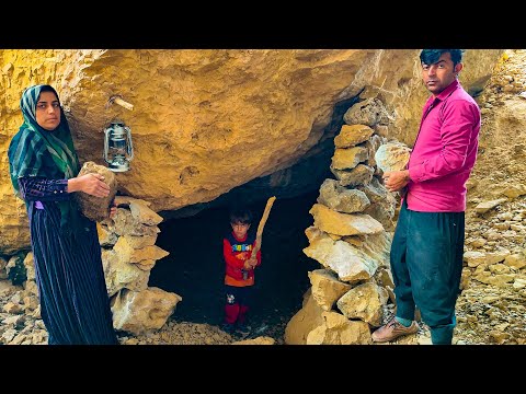 Building a shelter under a big stone for rainy days by