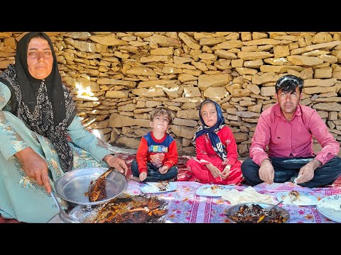 A nomadic woman cooked fish traditionally for her family