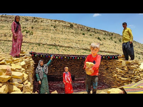 A nomadic family set up a black tent for their potential