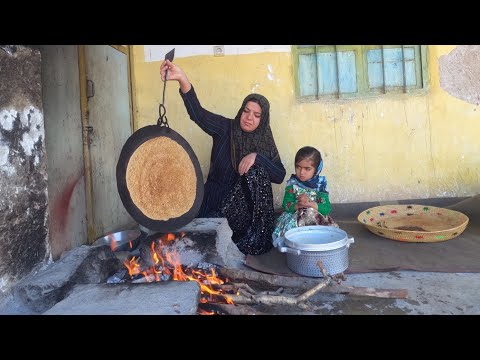 Cooking local bread by a village woman for breakfast in Iran