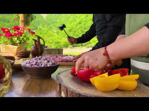 Juicy Meatloaf on a Spit Cooking outdoors in the Mountains